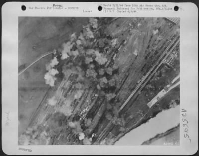 Thumbnail for Consolidated > This picture, taken at the height of the attack by B-17 Flying Fortresses of the 15th AAF on the Rome/Littorio railroad yards 3 March, shows strings of high-explosive bomb bursts across the target. Much of the rolling stock present was destroyed or