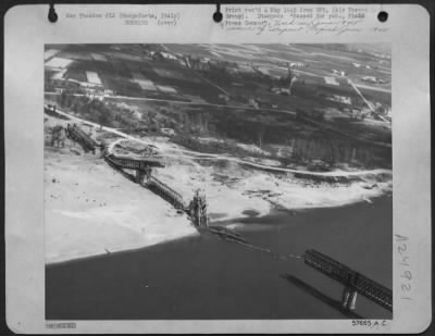 Thumbnail for Consolidated > Effectiveness Of The 12Th Af Repeated Attacks On Enemy Held Bridges In Northern Italy Is Illustrated By This Close-Up View Of The Span Across The Po River At Borgoforte, Italy, South Of Mantova.  Only Broken Bridges Like This One Greeted The Germans As Th