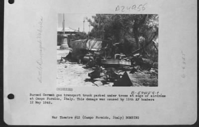 Thumbnail for Consolidated > Burned German Gas Transport Truck Parked Under Trees At Edge Of Airdrome At Campo Formido, Italy.  This Damage Was Done By The 15Th Air Force Bombers.  12 May 1945.