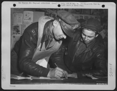 General > After Returning From A Raid Over Leipzig, Germany, T/Sgt. Charles D. Raglin, St. Louis, Missouri, Waits To Sign For His Wallet, While Capt. Alan F. Tucker, Hood River, Oregon Signs For His.  20 February 1944.