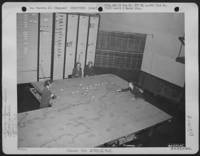 Thumbnail for General > Pfc. Vera Schulte Of St. Louis, Mo., Pfc. Ann Leger Of Fitchburg, Pa., Cpl. Jennie D. Johnson Of Miami, Fla., And Pfc. Elizabeth Freda Of Rankin, Pa., Work At The Plotting Board At An 8Th Air Force Base At Watford, England.  11 January 1944.