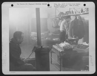 Thumbnail for General > 8Th Bomber Command Airman Keeps A Fire Going In A Coal Stove In The Nissen Hut Quarters At An Air Base Somewhere In England.