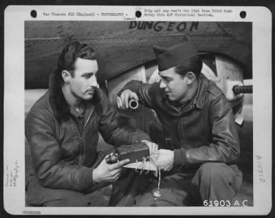 Thumbnail for Cameras,Gun > Crew Members Of The 303Rd Bomb Group Check The Machine Gun Camera Which Will Be Installed In The Boeing B-17 "Flying Fortress" In The Background.  England, 13 March 1945.