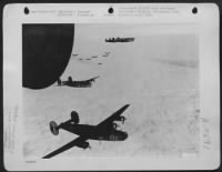 A Formation Of Consolidated B-24 Liberators Of The 392Nd Bomb Group Wing Their Way Over A Blanket Of Clouds En Route To Bomb Enemy Installations In Bielefeld, Germany.  10 March 1945. - Page 1