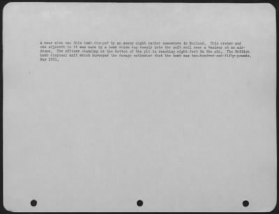 Intruder Damage > A Near Miss Was This Bomb Dropped By An Enemy Night Raider Somewhere In England.  This Crater And One Adjacent To It Made By A Bomb Which Dug Deeply Into The Soft Soil Near A Taxiway At An Airdrome.  The Officer Standing At The Bottom Of The Pit Is Reachi