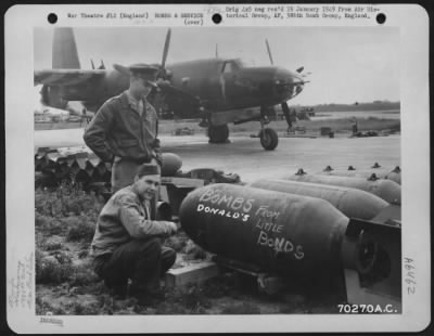 General > Two Men Inscribe A Note To Hitler On A Bomb Which Was Purchased Through The Sale Of War Bonds.  Soon This Bomb And Others Will Be Loaded On The Martin B-26 'Hell'S Angels' (Background) Of The 386Th Bomb Group For Another Devastating Raid On An Enemy Targe