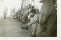 Thumbnail for June 1942, 2Lt Joseph F. Gill at end of line, head forward_5.38MB.jpg