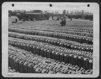 Thumbnail for Refueling > 9th Air Force soldiers are transferring gasoline from delivery trucks into gas cans at an advanced air base somewhere in France. Many of these cans will be flown to airstrips closer to the front lines for fighter bombers.