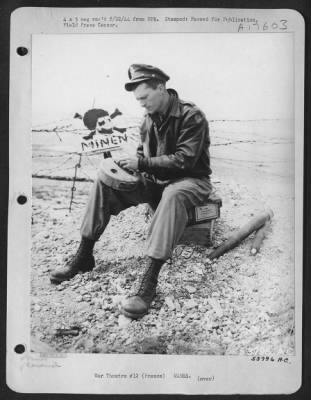 Thumbnail for Mines > Lt. B.E. Anderson of 8519 S. Olive St., Los Angeles, California, officer California, officer in charge of a 9th AF bomb disposal unit in France, defuses a German Teller mine found near a gun emplacement from which the Germans had been routed.