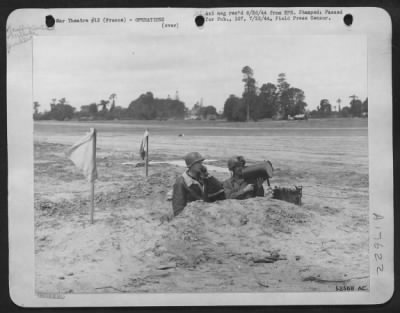 Thumbnail for General > Traffic control men, working from a foxhole on a 9th Air Force airstrip somewhere on the Normandy peninsula, signal with their "biscuit gun" to a pilot about to take-off. This strip was made ready by 9th Aviation Engineers of the 9th Air Force.