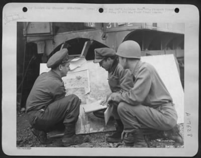 Thumbnail for General > The pilot (center) about to go on a Photographic mission is briefed with the aid of a map at a 9th AF base in France. (Left to right) are: 1st Lt. William J. Hohner, Franklin, Ohio; Lt. James M. Poole, Jr., Los Angeles, Calif., (pilot); and Capt.