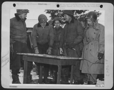 Thumbnail for General > Visiting pilots discuss air-ground co-operation with ground control officers of an Airborne Division. Left to right: Capt Francis P. McIntire; 1st Lt. Loyd J. Overfield; 1st Lt. Paul B. Johnson, Cambridge, Minn; Capt. J.E. Parker, Compton, Calif.