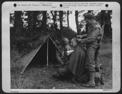 Thumbnail for General > 9th Air Service Command soldiers, keeping supplies moving to landing strips right on the heels of the retreating Nazis, take time out for an improvised haircut. The "barber" (right) Pvt. Bernard De Martini of Brooklyn, N.Y., a former longshoreman, is