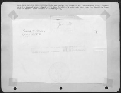 General > FRONT LINE BATH TUB WITH SHOWERS . . . While some prefer tea, these 9th AF, Fighter-Bomber pilots freshen up with a communal shower rigged up for their benefit at a point near their camp just behind the front lines in France. Note schedule