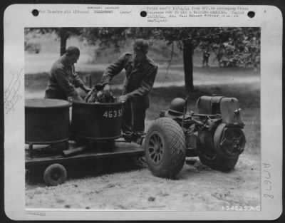 Thumbnail for General > FRANCE-Except for the rubber tires, this washing machine was made entirely of abandoned German equipment by U.S. Army 9th Air Force Service Command mechanics, Sgts. Eugene McLaughlin (left). Sparland, Ill., and Peter Gambutt, Mt. View, N.J.