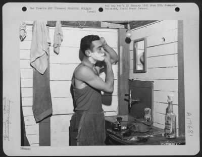 General > Lt. Arthur F. D'Agostino of Newark, New Jersey is shown doing his toilette in one corner of the "Shackteau," a two-story tent which he and a group of men built at a base somewhere in France.