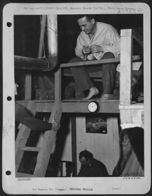 Thumbnail for General > Climbing the ladder to the second floor of a Pyramidal tent "Shackteau" built by men at a Ninth Air Force fighter-bomber base in France, Lt. Robert J. Todd of Tampa, Fla., finds Lt. Arthur F. D'Agostino of Newark, N.J., beating him to the sack.