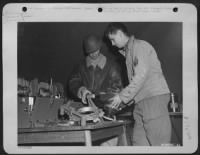 Thumbnail for Cpl Alfred Van Drake, Newark, N.J., and S/Sgt James E. Collins (right) of Chippewa Falls, Wisc., repair a camera at a Photo Recon Unit of the 9th AF in France. - Page 1