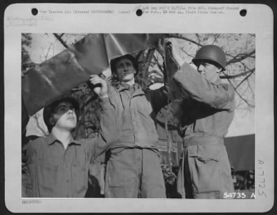 Thumbnail for Operations & Mapping > FRANCE-Photo Reconnaissance film is inspected after they return from a mission over enemy territory at a Ninth Air Force base somewhere in Europe. Left to right are: Pfc Carl A. Forsman, Olympia, Wash.; T/Sgt Arba Harper, Lawton, Okla.; and John