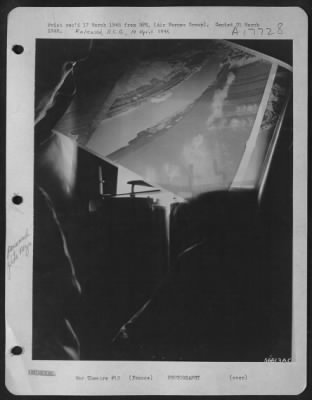 Thumbnail for Operations & Mapping > FRANCE--Development completed, film is viewed against a light to make a quick appraisal. Pfc. Preston Reichard, of Columbus, Ohio, checks for quality and coverage.