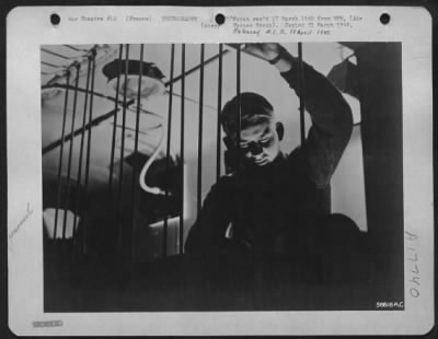 Thumbnail for Processing > Cpl. Delbert Mullins, of Waynesburg, Ky., makes proper adjustments on the immersion bars. These long bars allow threading of the photo paper strips through the deep chemical tanks, and act as guides.