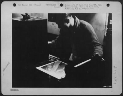 Thumbnail for Processing > FRANCE--Printer head is adjusted. Negative is judged for density thru the viewer so that proper print exposure can be made. Pfc. Edward Speaks, of Ridgeland, Miss., gives the final adjustment of printing light intensity before the bulk order is