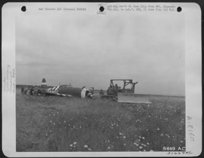 Thumbnail for General > Crash landed fighter plane near 834th Engineer Aviation Battalion bulldozer on invasion coast St. Laurent Sur Mer, France.