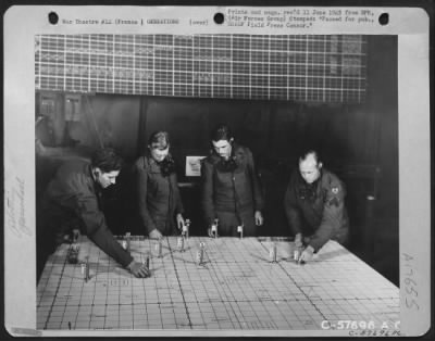 Thumbnail for General > The Markers On The Numbered Plotting Table Refer To The Number Of The Raid And Number Of Planes Participating In A Mission.  Men In The Picture Are: (Left To Right), Cpl. William Saver Of Brooklyn, N.Y.; Pfc. Raymond Emmerick Of Shamokin, Pa.; Sgt. Ellis