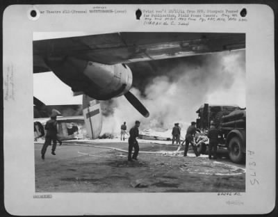 Thumbnail for General > British Fire Fighters Battle The Blaze That Broke Out In A Consolidated B-24 Liberator Of The 15Th Air Force While It Was Unloading Gasoline At An Advanced Air Base In Southern France.  The Plane Was Destroyed, But Other Planes, Parked Nearby Were Unscath