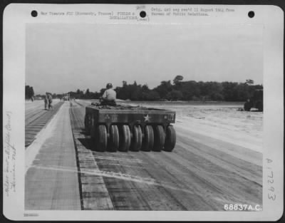 Thumbnail for Construction- Airfields > Just A Few Miles Behind The Front Lines In Normandy, France, 9Th Air Force Aviation Engineers Constructed Emergency Landing Strips With "Hessisn Mat" Used For Surfacing.  After The Selected Site For The Airstrip Is Graded And Leveled, The Mat, A Tar-Paper