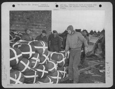 Thumbnail for Supplies > Members Of The 9Th Troop Carrier Command, Stock Parapacks At An Base Somewhere In France.  16 January 1945.