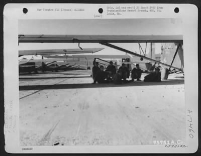 Thumbnail for General > Air Crews Of The 439Th Troop Carrier Relax Underneath The Wing Of One Of The Many Cg-4 Gliders Lined Up At An Air Base Somewhere In France, 26 March 1945.