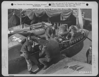 Thumbnail for Consolidated > A ground crew repairs the Curtiss P-40 "Dell"; in the background the P-40 "Flaming Mame" awaits an overhauling. Amchitka, Aleutian Islands. 12 October 1943.