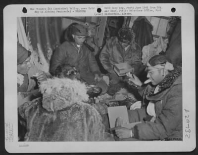 Thumbnail for Consolidated > A kitchen was set up behind the lavatory of the inverted Douglas C-47 which crashed in Cathedral Valley, Alaska. Meals were served in the fuselage which had become shelter for fourteen men. Blood Plasma boxes were used for stools, while tasty meals