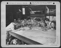 Thumbnail for In a map briefing session at an Airfield, Mareeba, Australia, before going on a mission are left to right: Capt. David W. Hassemer, Operations Officer, 2nd Lt. Jacob H. Franz, Bombardier, Lt. John A. Crockett, Navigator, Lt. Raymond B. Holsey, Pilot - Page 1