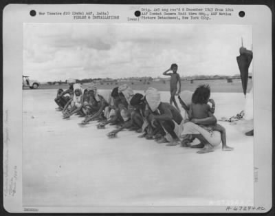 Thumbnail for Consolidated > Before Camouflage Is Applied To The Newly Constructed Runway At Ondal Army Air Base I India, Natives Brush Off The Concrete To Remove All Foreign Matter In Order That The Camouflage Can Be Applied Properly.  305Th Service Group, 1943.