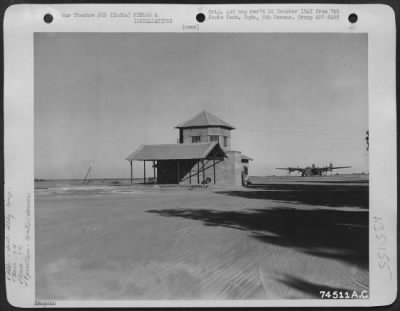 Thumbnail for Consolidated > Side View Of The Control Tower And Operations Office At Pandaveswar, India, With A Consolidated B-24 Of The 9Th Bomb Squadron, 7Th Bomb Group Parked In The Background.