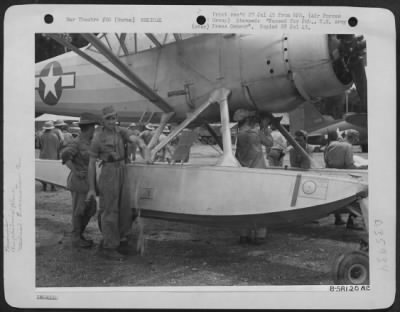 Consolidated > Security Restrictions On Light Amphibious L-1 Planes That Evacuated Wounded During The Burma Campaign Have Now Been Lifted.  Liaison Pilot T/Sgt. James D. Mccullough Of Westport, Ind., Bails Water Out Of The Pontoons Of His Amphibious L-1, While Mechanic