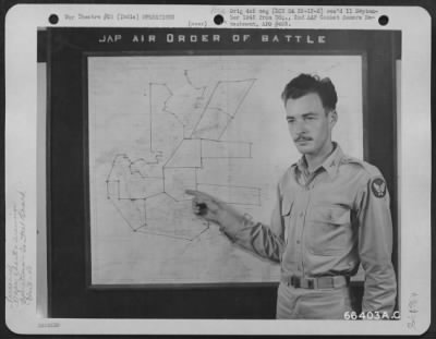 Thumbnail for Consolidated > Lt. Francis J. Cahill, Intelligence Officer Of The 40Th Bomb Group, Points To A Wall Chart Showing Jap Air Order Of Battle - One Of The Wall Panels In The War Room At A 20Th Bomber Command Base In India.  These Panels Keep The Men Informed On The Latest D