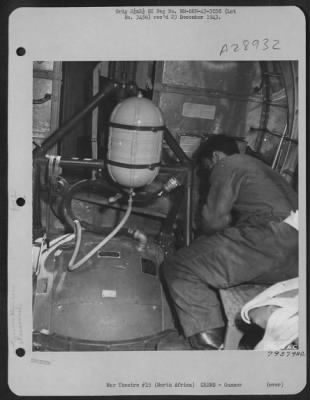 Consolidated > Sgt. Arthur B. Raymond, ball turret gunner from Oak Park, Illinois, tests his turret operation before take-off on a mission from his base somewhere in North Africa. 29 July 1943.