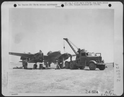 Thumbnail for Consolidated > With Maj. Gen. Doolittle's Strategic Air Force, North Africa-Maintenance crew works on engine of Lockheed P-38 which was hit by 2-20 mm. shells in a raid over Sicily.