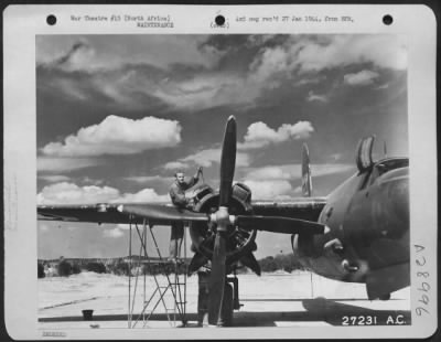 Consolidated > Sgt. Leo E. Walker, Fitchburg, Mass., gets in his licks on one of his AAF Martin B-26 Marauders 2,000-horsepower engines during a lull in operations at a 12th AAF bomber base. Having flown 455 hours, crew chief Walker's "bee-two-six" is one of the