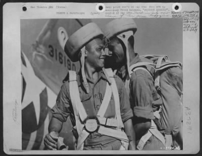 Thumbnail for Consolidated > Rangoon Assault - Killing Japs Is Great Sport To This Husky Gurkha Paratrooper, Who Smiles As A Fellow Member Of His Unit Helps Him Buckle On His Equipment While He Waits His Turn To Board A Usaaf C-47. Pilots Of The Combat Cargo Task Force, Under Major G