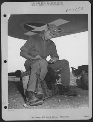 Thumbnail for Consolidated > 1st Lt. Wilbur W. Raffensperger, pilot from Elizabethtown, Pennsylvania, fills out his log after landing at his base in North Africa from a mission over Italy. 29 July 1943.