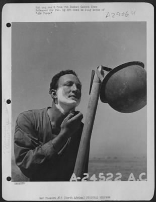 Thumbnail for Consolidated > Using Steel helmet for basin, soldier of 9th U.S. Air Force in North Africa shaves.