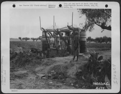 Consolidated > Personnel of the 90th Photographic Reconnaissance Wing bathe in the improvised shower at an air base somewhere in North Africa. 18 June 1943.