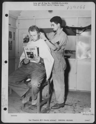 Consolidated > Sgt. Kim Edgmand of Enterprise, Ore., cuts the hair of Sgt. Cecil Hale of Legrand, Ore. In the barber shop of the 43rd Service Group at their base somewhere in North Africa. 1943.