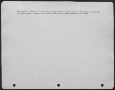 Consolidated > North Africa-Veteran of 21 missions, "Sheepherder" is hauled in to the Reclamation and Salvage Yard aboard mobile float to be dismantled and valuable parts reclaimed for reissue.