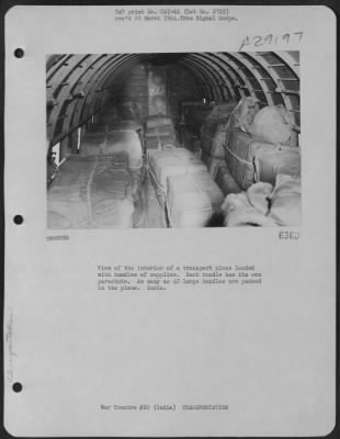 Thumbnail for Consolidated > View of the interior of a transport plane loaded with bundles of supplies. Each bundle has its own parachute. As many as 40 large bundles are packed in the plane. India.