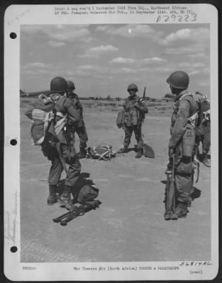 Consolidated > Paratroops slide into 'chutes. NORTH AFRICA.